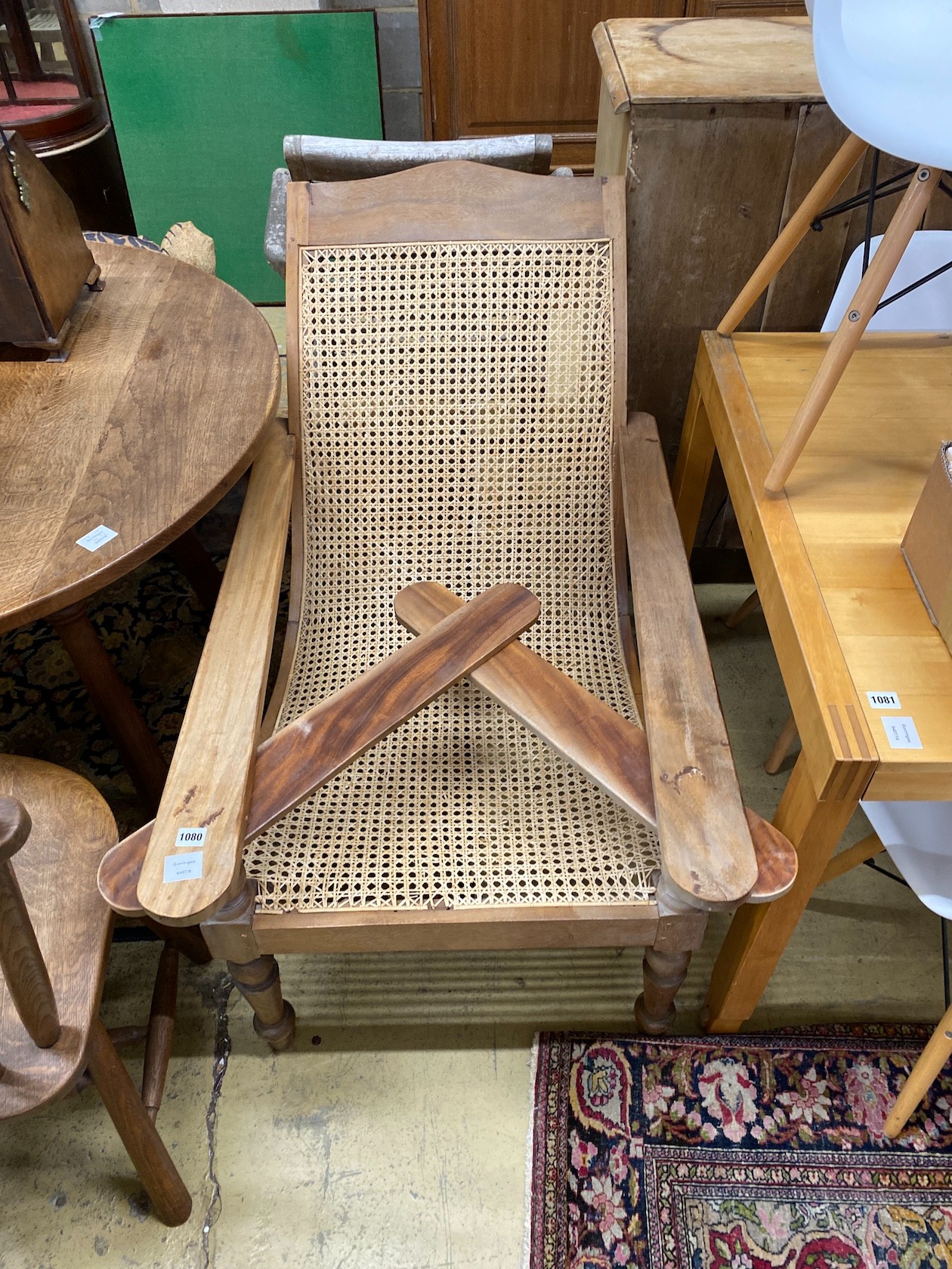 A caned hardwood plantation chair, width 66cm, depth 100cm, height 90cm
